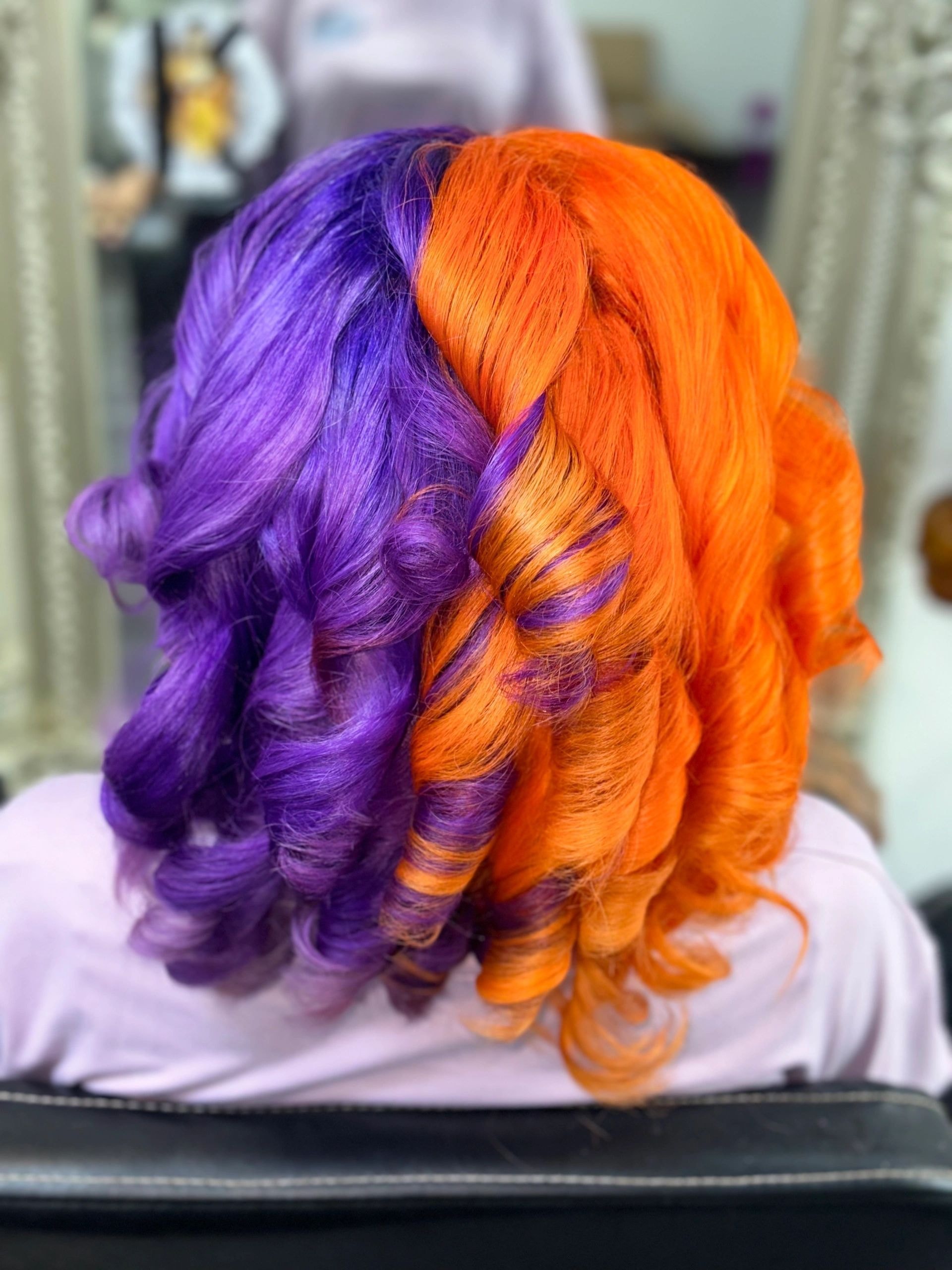 Hair transformation — bold split-dye purple and orange colour