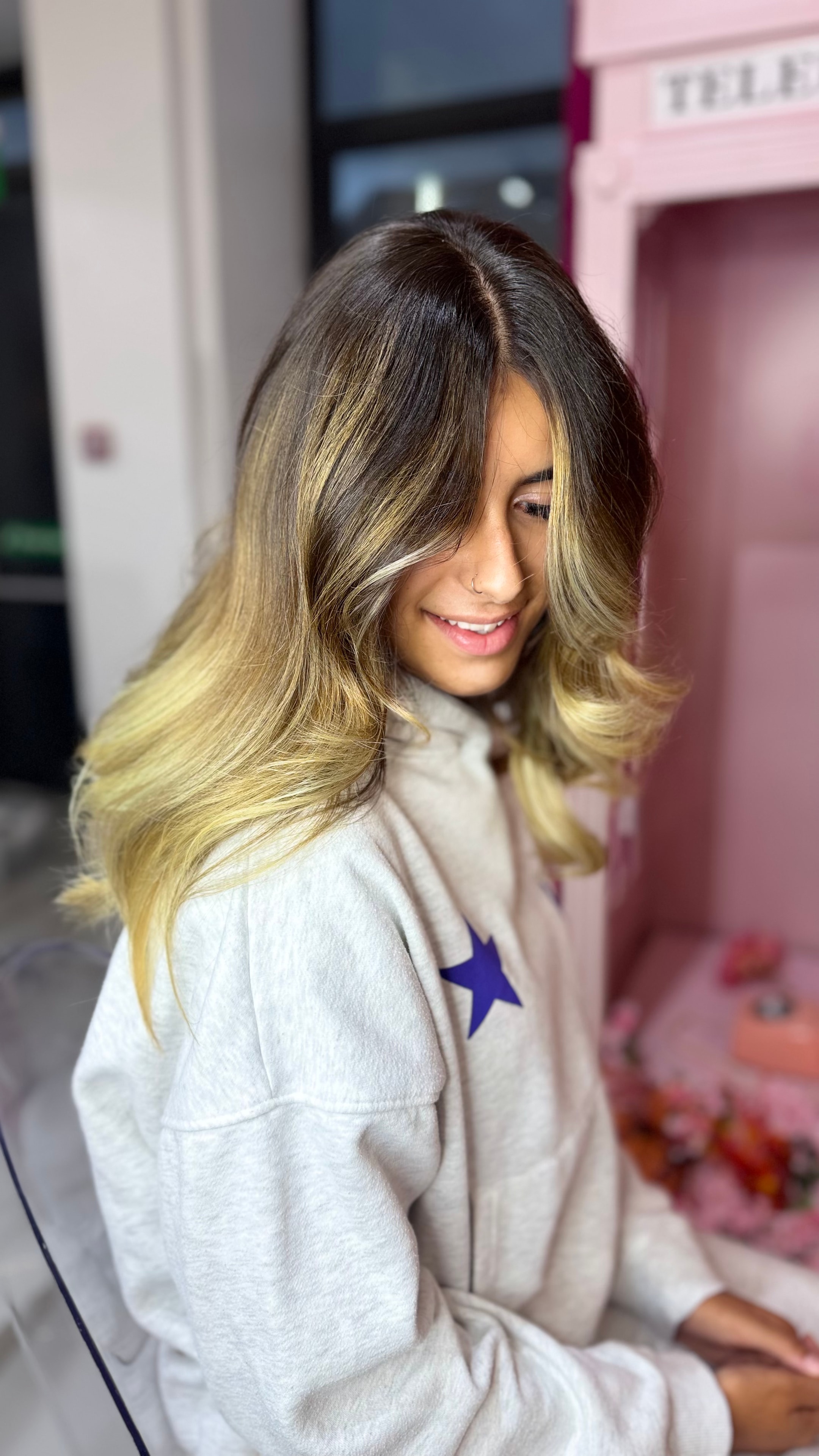 Hair transformation — blonde balayage styled in the salon