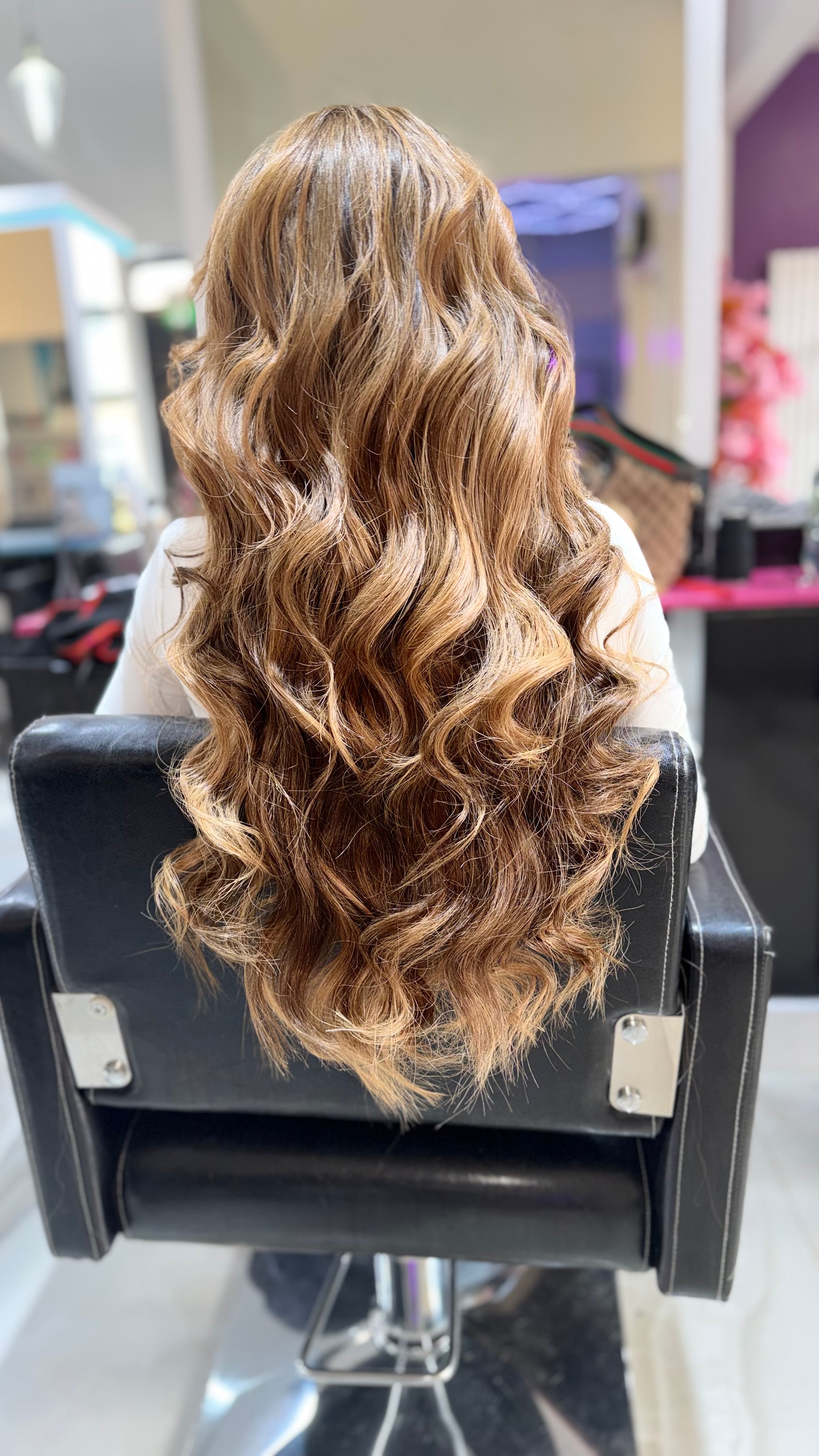 Hair transformation — long honey bronde waves styled in the salon